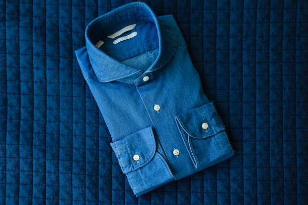 A folded blue shirt on a blue background