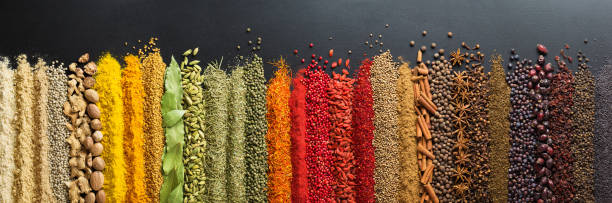 istock Colorful collection spices and herbs on background black table. Mediterranean condiments for decorating packing with food. 1130024328