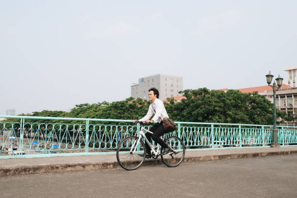 istock Going everywhere by his bike. Side view of young businessman looking forward while riding on his bicycle 1130025253