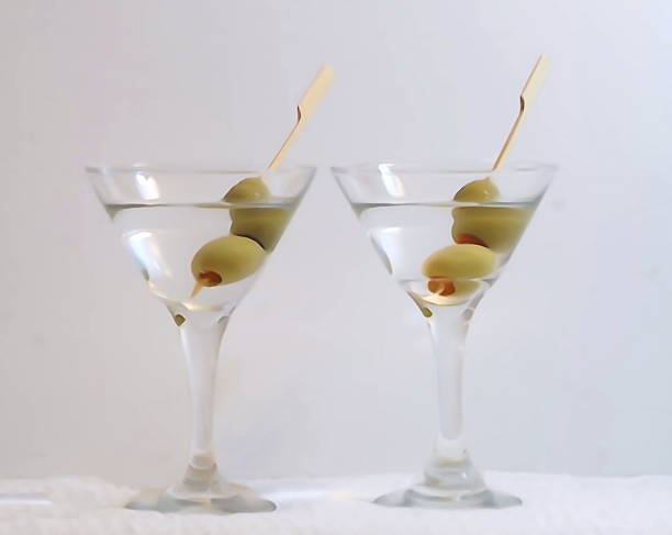 istock Two martini glasses with vodka and olives 1130026966