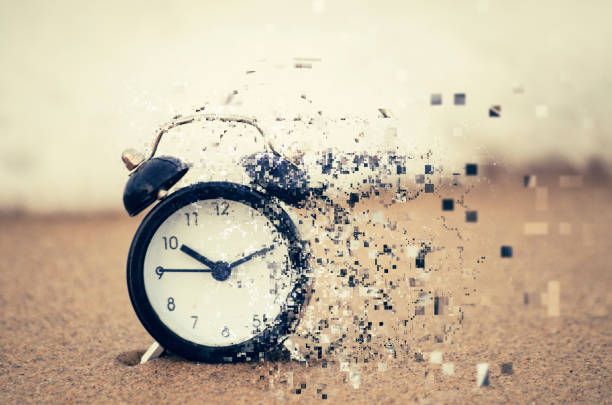 istock Pixelated effect of clock face over beach background and sandy beach for time management concept 1130026980