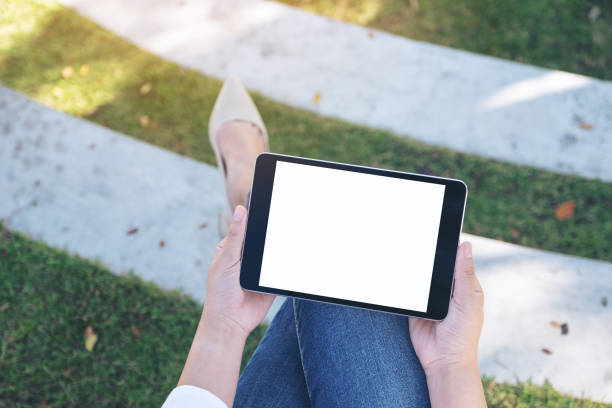 istock a woman holding and using black tablet pc with blank white desktop screen 1130029840