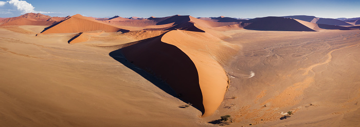 Aerial view Panorama of Namib-Naukluft National Park Orange Sand Dunes. The famous Dune 45 of Namib-Naukluft National Park in the center of the panorama. XXXXL  stiched Panorama Shot. Namib-Naukluft National Park, Sossusvlei, Namib Desert, Sesriem, Namibia, Africa.