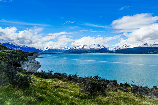 A Beautiful Scenic Drive at Lake Pukaki in Aoraki Mount Cook National Park with the Snowcapped Mouatain and Blue Sky Clouds - South Island, New Zealand