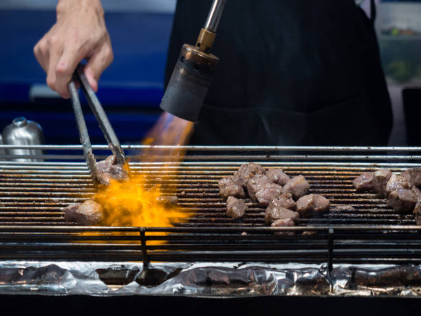 istock Close up hand of chef using flame torch burn on Japanese wagyu beef. 1130033036