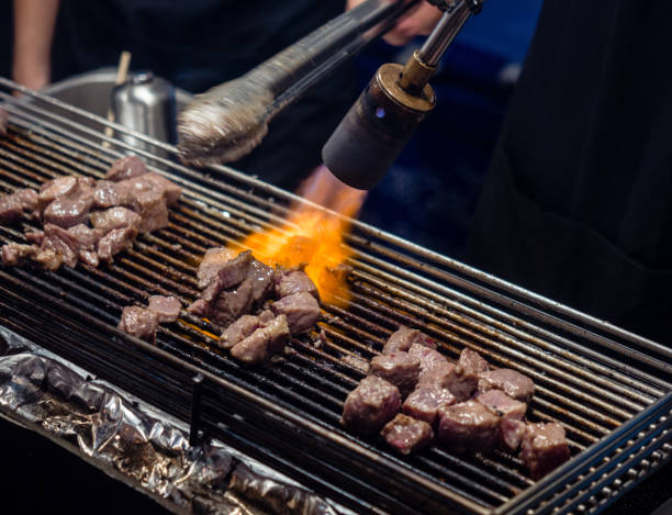 istock Close up hand of chef using flame torch burn on Japanese wagyu beef. 1130033040