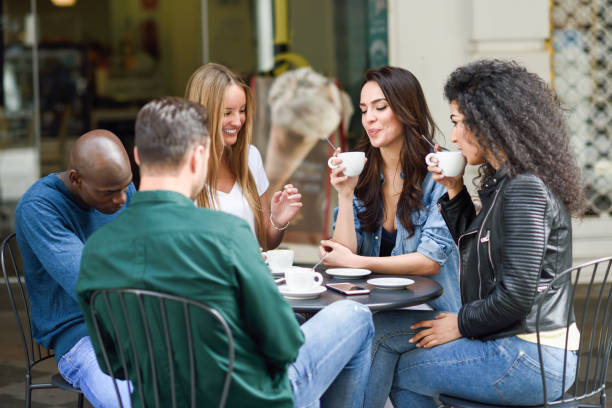 istock Multiracial group of five friends having a coffee together 1130036848