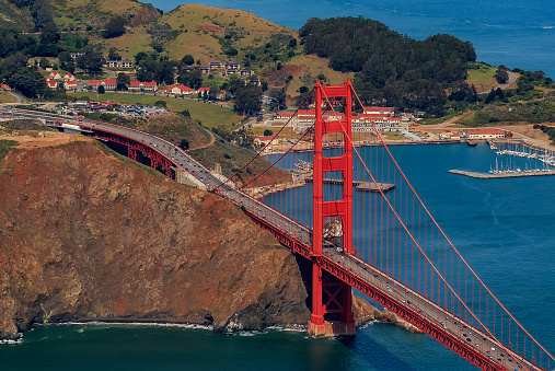 Aerial view of the North tower of Golden Gate Bridge and Sausalito in Marin County, flying over San Francisco, USA