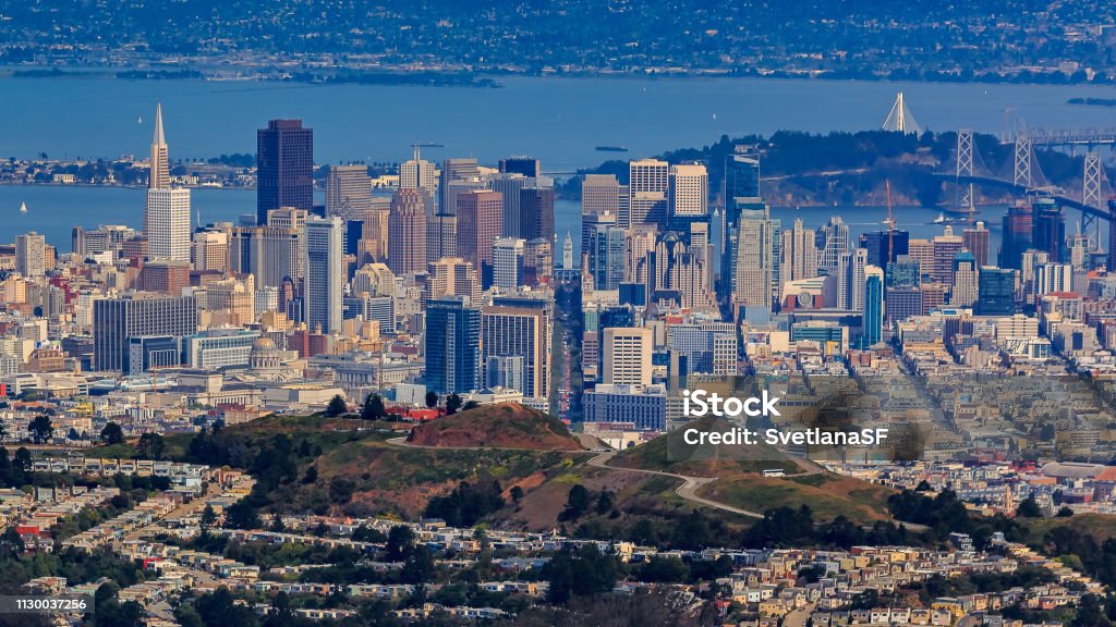Aerial view of downtown San Francisco and Financial District skyline with Sutro tower in the foreground, flying over Twin Peaks Aerial view of downtown San Francisco and Financial District skyline with Twin Peaks in the foreground, circa 2015 San Francisco - California Stock Photo
