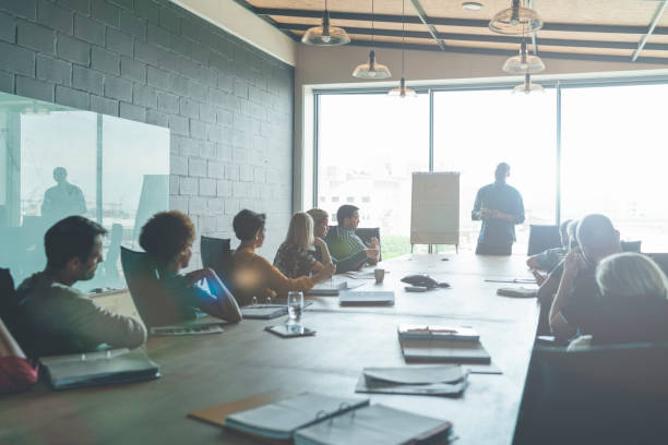 istock Businessman sharing ideas with team members in office 1130040012