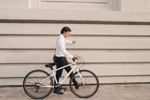 istock Businessman checking the time while commuting on his bicycle 1130040015