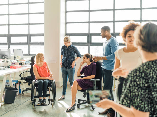 istock Disabled businesswoman discussing with colleagues 1130040877