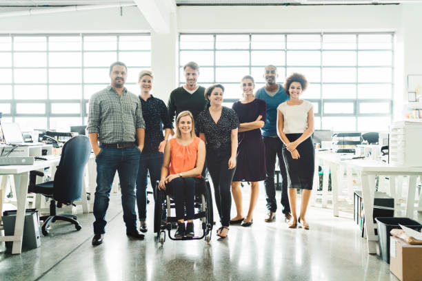 istock Team of business people smiling in creative office 1130040887