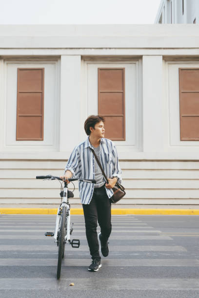 istock Man looking at his smartphone while walking in the city street 1130042111