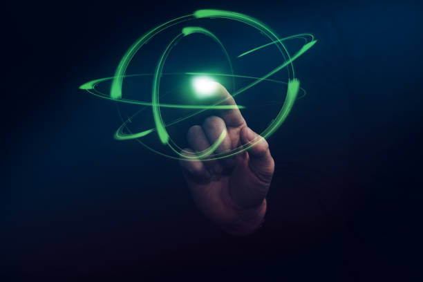 istock Human forefinger touches green atom. Mixed media. 1130046171