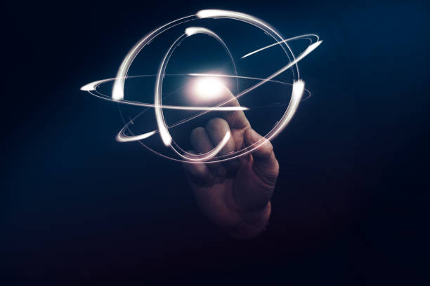 istock Human forefinger touches yellow atom. Mixed media. 1130046210