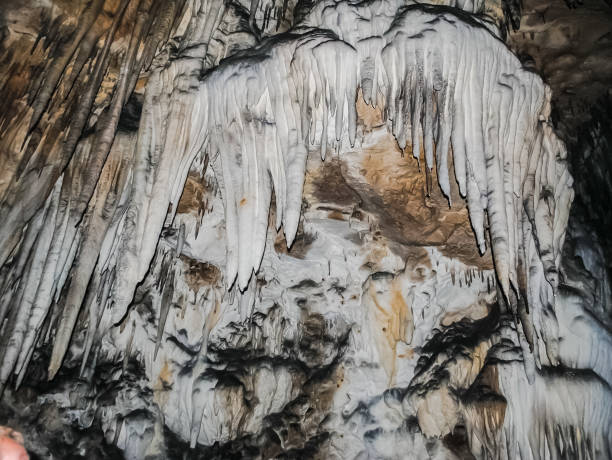 Stalactites on the walls of the karst cave.