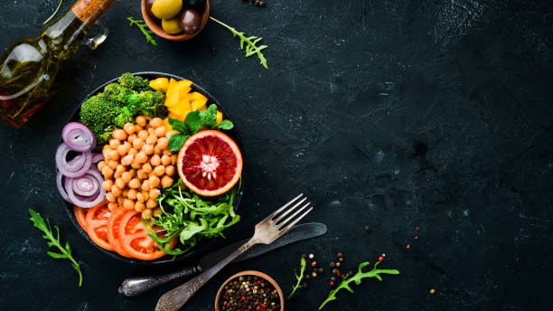 istock Buddha bowl. Turkish peas, broccoli, tomatoes, onions. Top view. Free space for your text. 1130049376