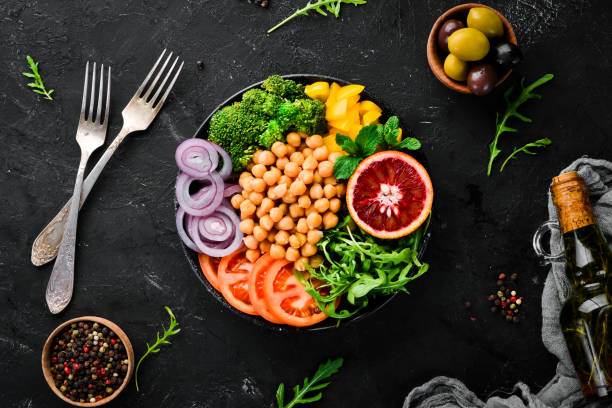 istock Buddha bowl. Turkish peas, broccoli, tomatoes, onions. Top view. Free space for your text. 1130049379