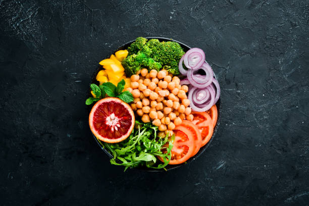 istock Buddha bowl. Turkish peas, broccoli, tomatoes, onions. Top view. Free space for your text. 1130049420