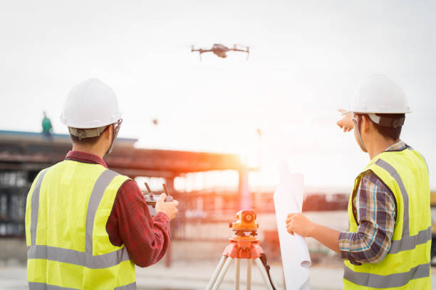 Engineer surveyor working with drone at construction site Engineer surveyor working with theodolite at construction site af_istocker stock pictures, royalty-free photos & images