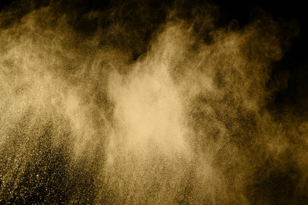 istock Golden powder explosion on black background. Freeze motion. 1130052933