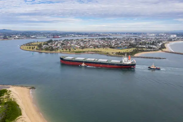A large coal transport ship entering Newcastle Harbour - Newcastle is one of the largest coal export ports in the world providing thermal and coking coal to Asia and beyond.