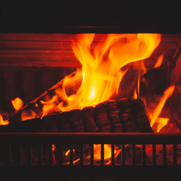 istock Firewood burns in fireplace, square 1130054358
