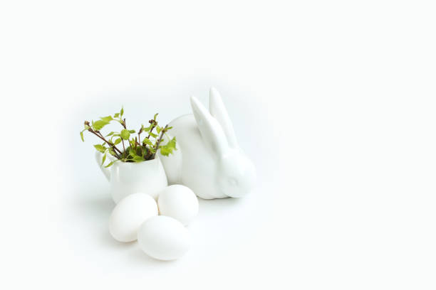 istock happy easter egg, easter bunny and branch with young leaves 1130054369