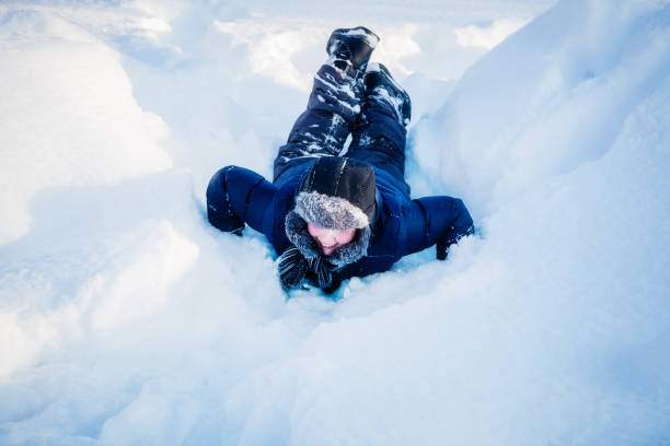 istock Boy in winter is playing in the snow 1130054423
