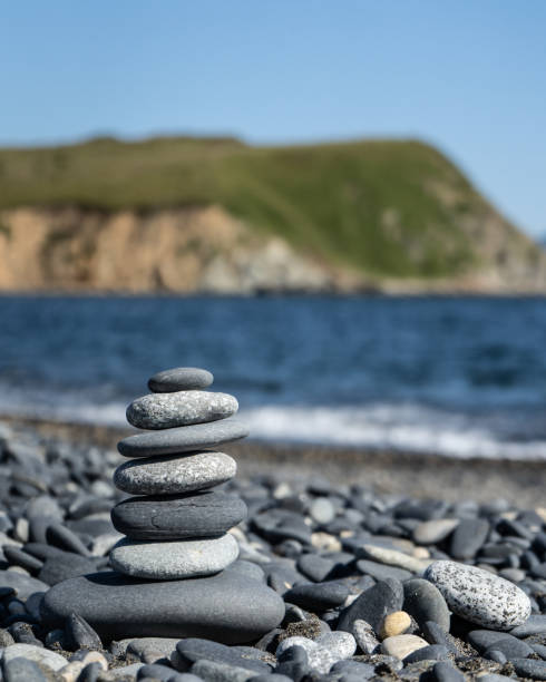 istock Balanced stone pyramid on the beach with black and grey stones. 1130054465