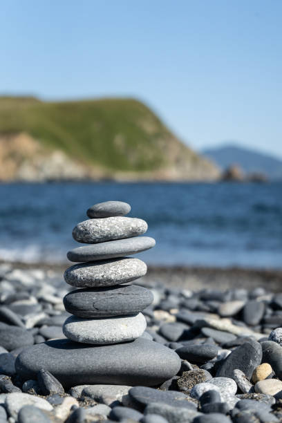 istock Balanced stone pyramid on the beach with black and grey stones. 1130054515