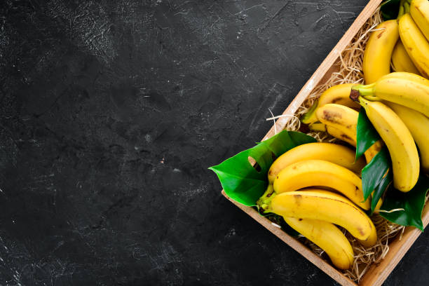 istock Fresh bananas in a wooden box. Top view. Free copy space. 1130058715