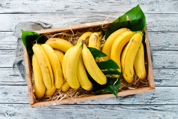 istock Fresh bananas in a wooden box. Top view. Free copy space. 1130058774
