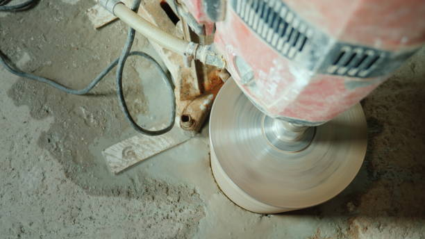 Powerful power tool drills a hole in a concrete ceiling stock photo