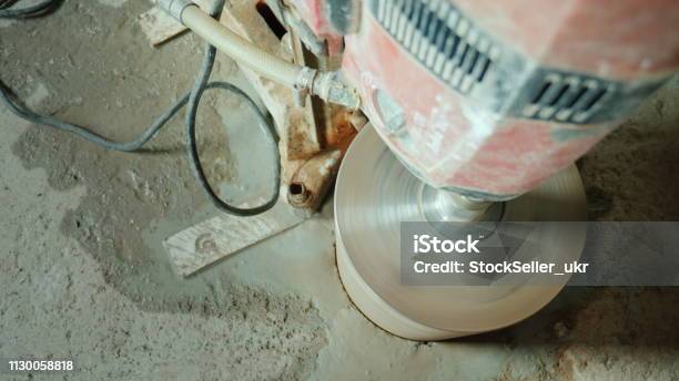 Powerful Power Tool Drills A Hole In A Concrete Ceiling Stock Photo - Download Image Now