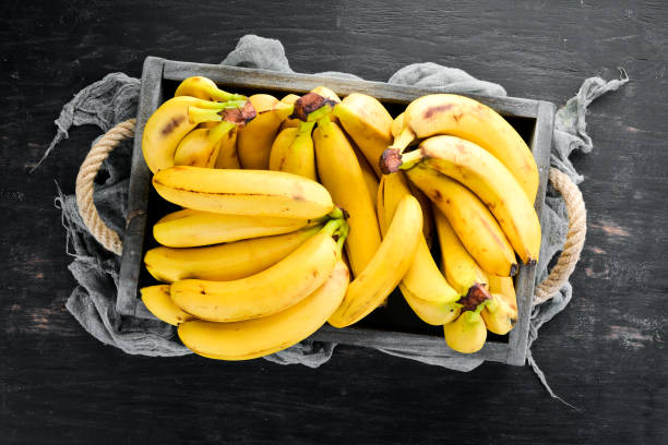 istock Fresh bananas in a wooden box. Top view. Free copy space. 1130058872