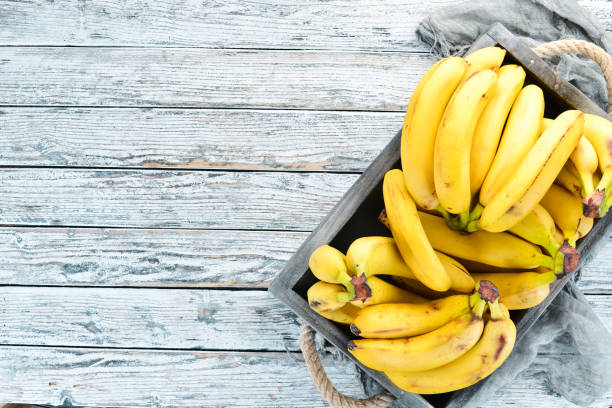 istock Fresh bananas in a wooden box. Top view. Free copy space. 1130058940