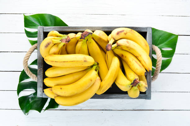 istock Fresh bananas in a wooden box. Top view. Free copy space. 1130058985