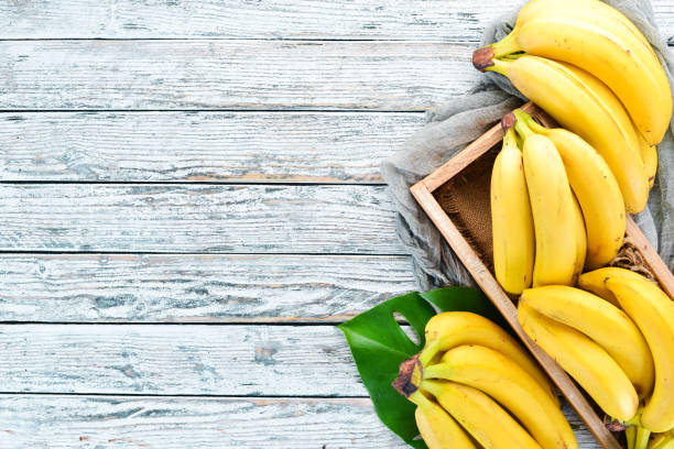 istock Fresh bananas in a wooden box. Top view. Free copy space. 1130059030