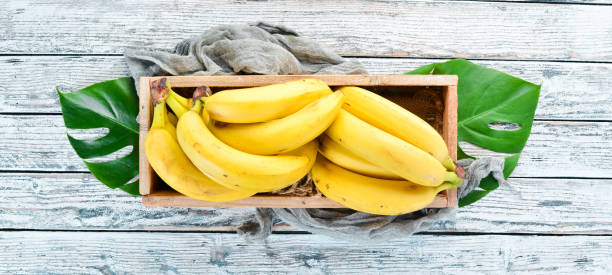 istock Fresh bananas in a wooden box. Top view. Free copy space. 1130059053