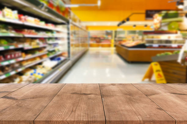 istock Empty wood table top on shelf in supermarket blurred background 1130059055