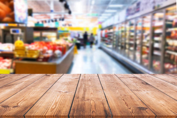 istock Empty wood table top on shelf in supermarket blurred background 1130059056