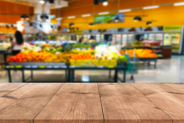 istock Empty wood table top on shelf in supermarket blurred background 1130059060