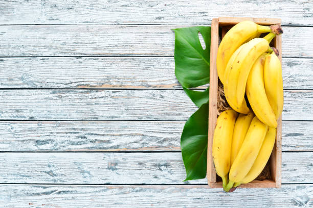 istock Fresh bananas in a wooden box. Top view. Free copy space. 1130059075