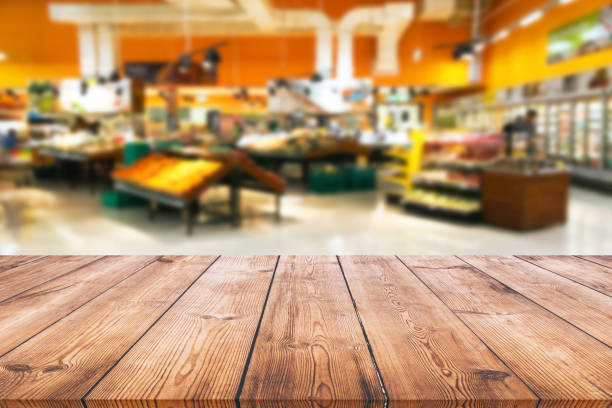 istock Empty wood table top on shelf in supermarket blurred background 1130059676