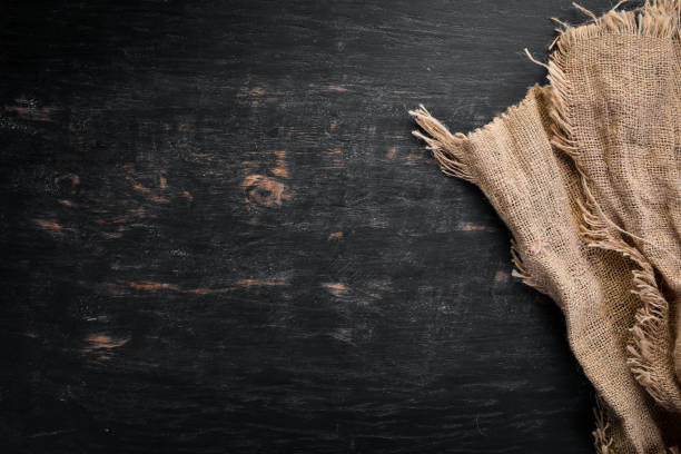 istock Old linen fabric on a black wooden background. 1130061293