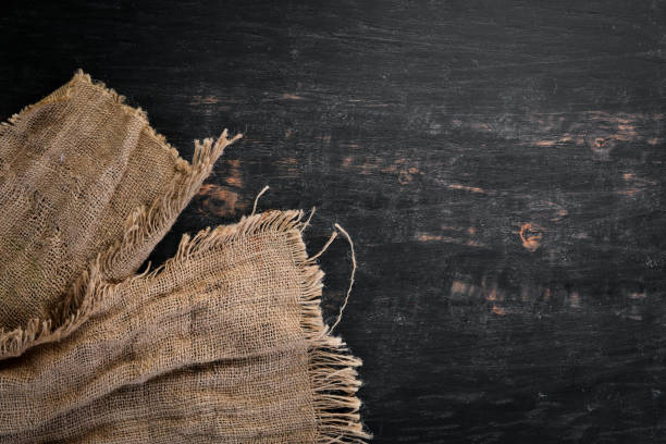 istock Old linen fabric on a black wooden background. 1130061314