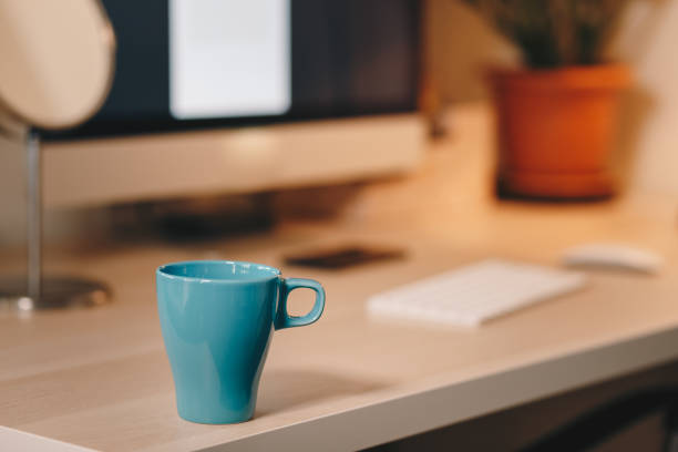 istock Coffee mug on a wooden computer desk, home office details 1130064069