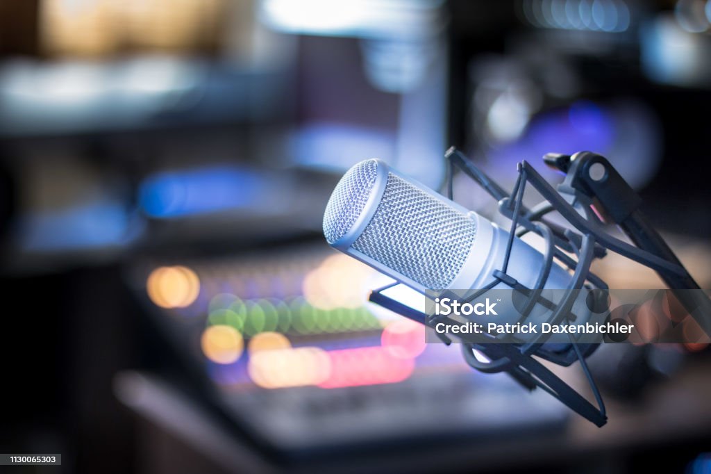 Microphone in a professional recording or radio studio, equipment in the blurry background Professional studio microphone, recording studio, equipment in the blurry background Radio Stock Photo